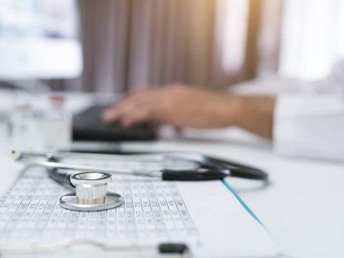 Close-Up Of Hands Of A Nurse Typing On Laptop